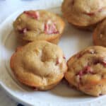 Strawberry rhubarb muffins with a dash of cinnamon, using greek yogurt instead of milk and applesauce instead of oil. This is a great way to bake with rhubarb and eat up some of your strawberries too! | trialandeater.com