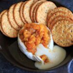 Peach Jalapeno Honey Baked Brie - a delicious party appetizer or game time food. Dip with crackers or veggies!