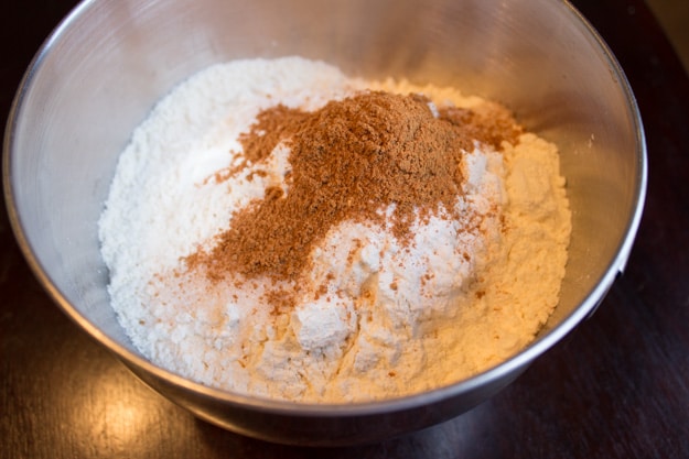 flour and spices in mixing bowl ready to make applesauce pumpkin bread