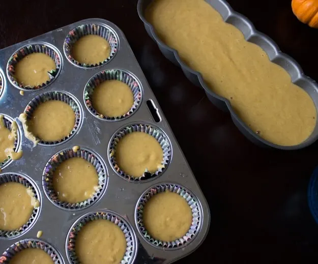 pumpkin bread batter in muffin pan and bread pan ready to go in the oven