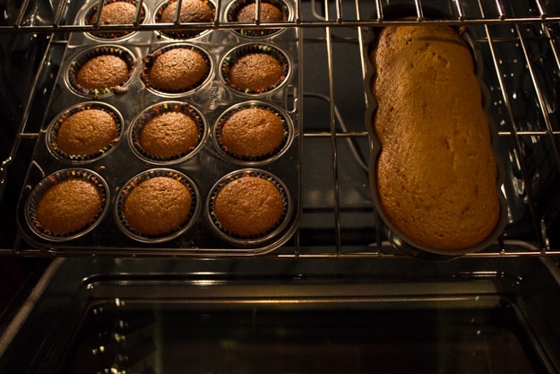 applesauce pumpkin bread in muffin pan and bread pan in oven, baked and ready to take out