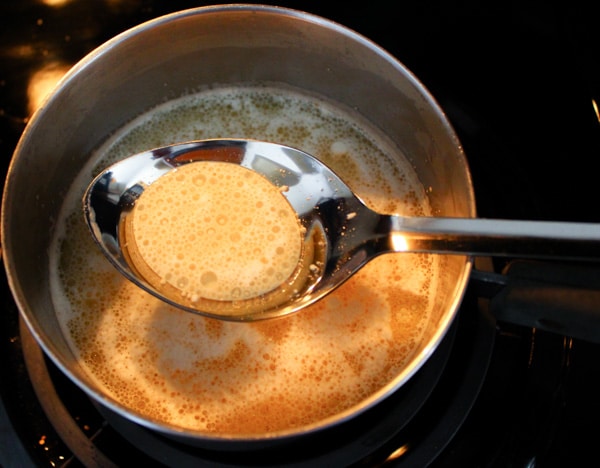 melted butter on stove with spoonful