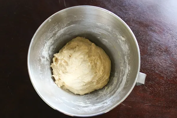 bread dough in mixing bowl before making into rolls