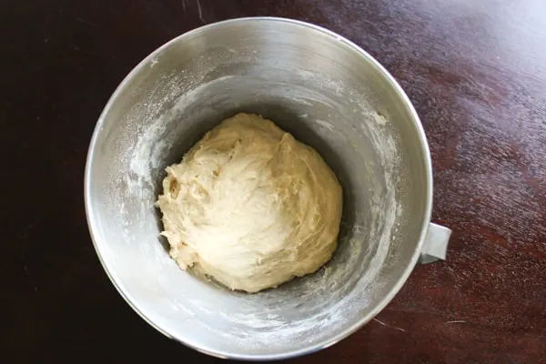 bread dough in mixing bowl before making into rolls