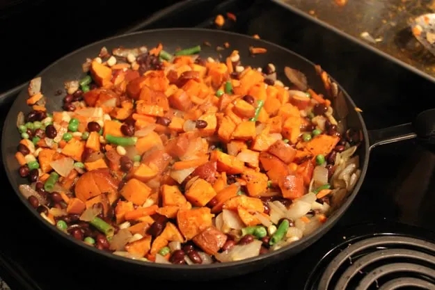added sweet potatoes to mixed veggies on stove top pan