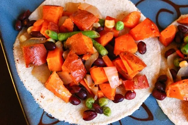 sweet potato black bean veggie honey lime tacos on blue plate
