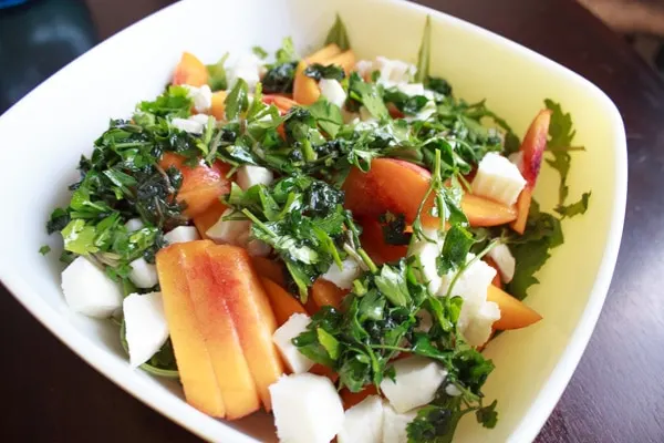 Peach and Arugula Salad in large serving bowl