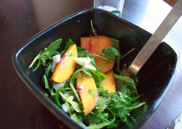 Peach and Arugula Salad one serving in bowl with fork