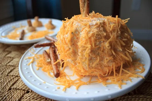A pumpkin shaped cheese ball that is a perfect appetizer to serve at a Halloween or other Fall-themed event. Super cute and delicious!