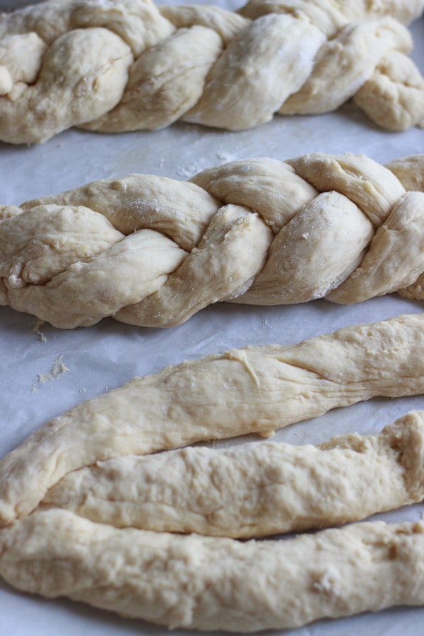 braiding challah bread dough into 3 loaves