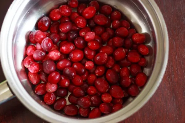 Slightly sweet cranberry sauce flavored with honey and fruit juice. A perfect vegetarian and gluten free side dish for Thanksgiving or holiday dinners. 