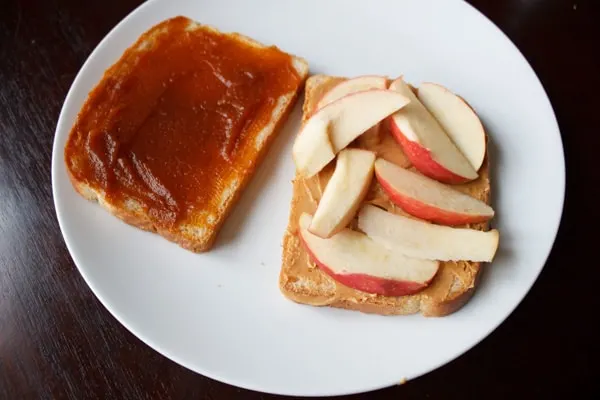 Peanut butter, pumpkin butter, and apple sandwich. A unique, crunchy and flavorful combination for all your autumn cravings.