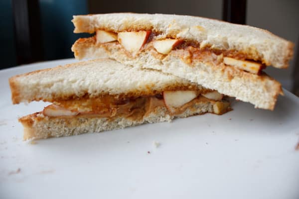 Peanut butter, pumpkin butter, and apple sandwich. A unique, crunchy and flavorful combination for all your autumn cravings.