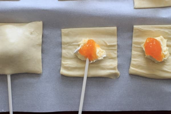 puff pastry squares with brie chunk and topped with apricot jam