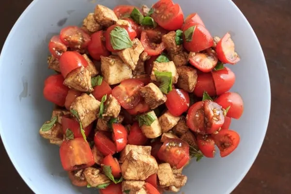 what not to do with your chopped Caprese salad - mixing in the balsamic makes for a brown cheese salad!