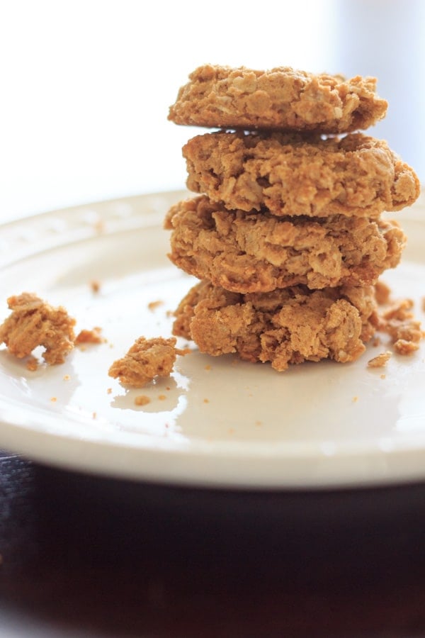 4 peanut butter cookies stacked on white plate