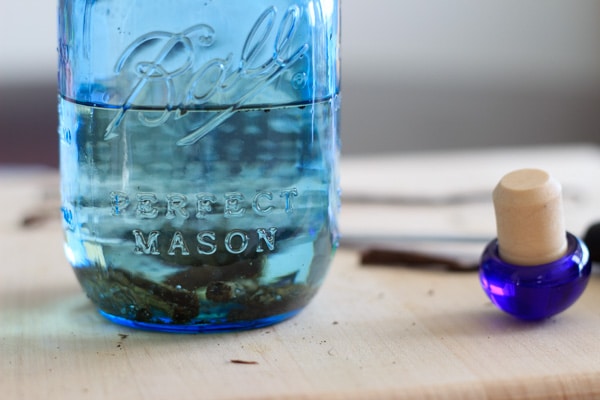 mason jar half filled with vodka and vanilla beans for making vanilla extract