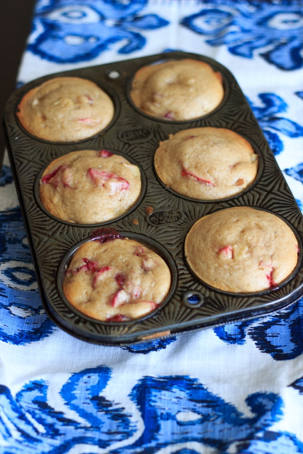 Strawberry rhubarb muffins with a dash of cinnamon, using greek yogurt instead of milk and applesauce instead of oil. This is a great way to bake with rhubarb and eat up some of your strawberries too! | trialandeater.com
