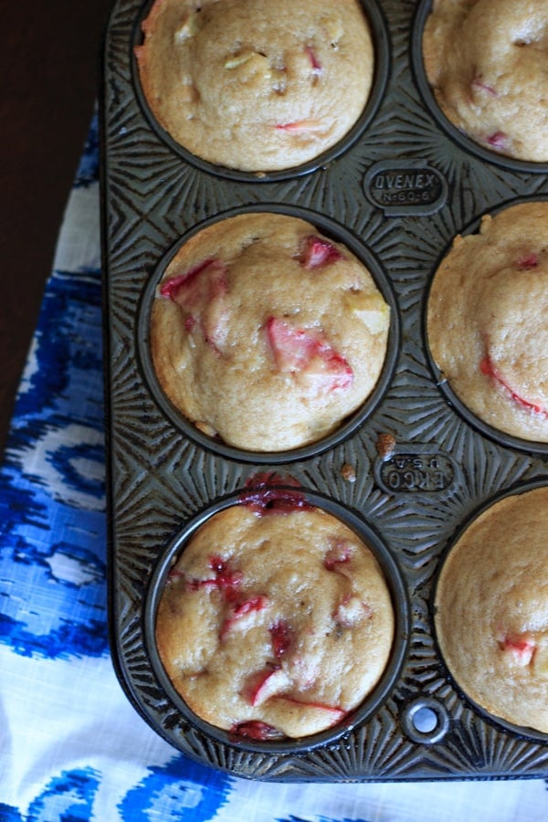 Strawberry rhubarb muffins with a dash of cinnamon, using greek yogurt instead of milk and applesauce instead of oil. This is a great way to bake with rhubarb and eat up some of your strawberries too! | trialandeater.com