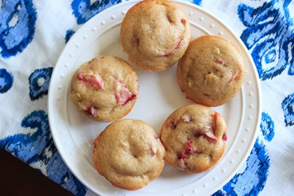 Strawberry rhubarb muffins with a dash of cinnamon, using greek yogurt instead of milk and applesauce instead of oil. This is a great way to bake with rhubarb and eat up some of your strawberries too! | trialandeater.com
