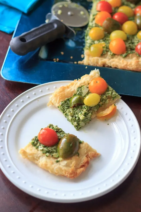 Two pieces of tomato tart on white plate
