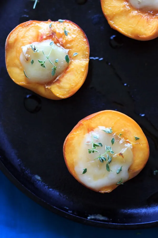 close up of honey baked peaches with thyme