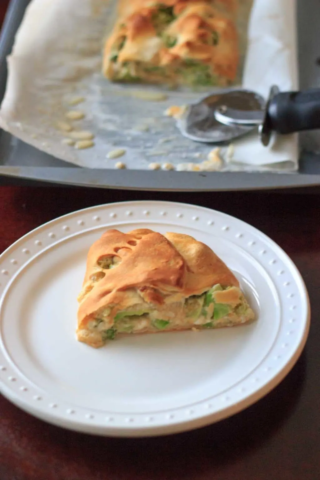 A slice of broccoli crescent wrap on a plate