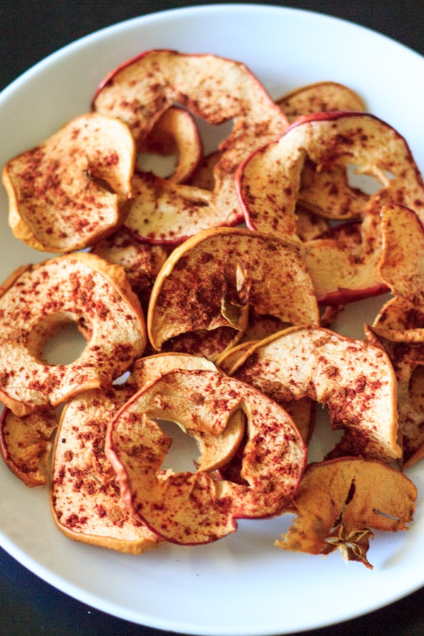 baked cinnamon apple chips on white plate