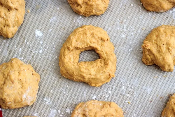 Pumpkin bagel dough on parchment