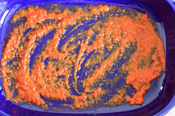 picture video showing how to add the layers of ziti - sauce, half of ziti, ricotta cheese mixture, more red sauce, remaining ziti, remaining sauce, shredded cheese to top
