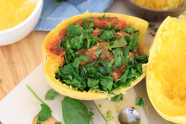 half of cooked spagheti squash with spinach and sauce added