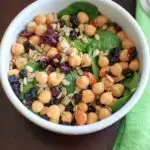 Spinach Chickpea Salad - a bowl of deliciousness! Protein, veggies, fruit, seeds, and nuts = flavor that will make you say goodbye to your normal boring salad.