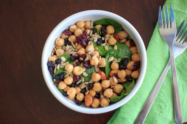 Spinach Chickpea Salad - a bowl of deliciousness! Protein, veggies, fruit, seeds, and nuts = flavor that will make you say goodbye to your normal boring salad.