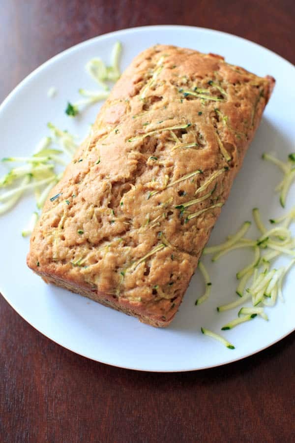 Skinnier Zucchini Bread on plate with zucchini shreds 