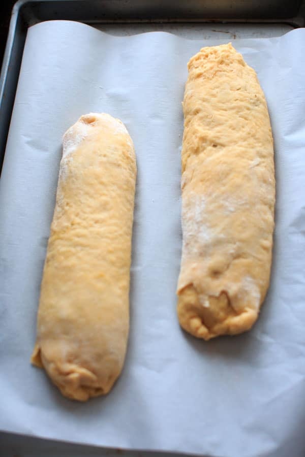 2 loaves of potica ready to bake on baking sheet