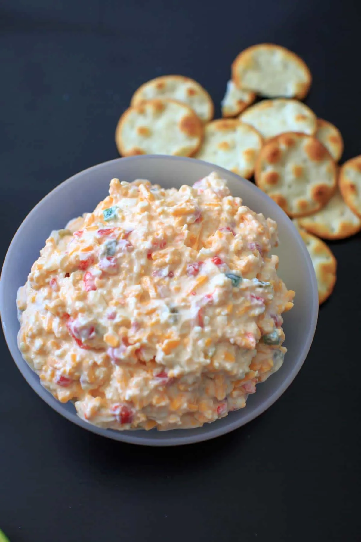 Skinny Jalapeno Pimento Cheese in clear bowl with crackers on side