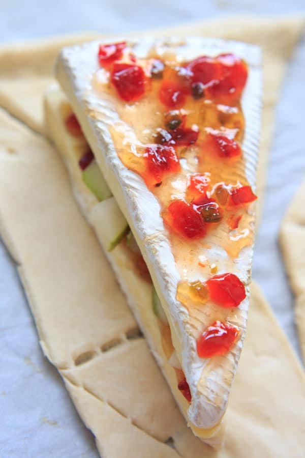 Indulge a little with this Baked Brie cheese with Sweet Hot Pepper Jelly and Pear. Hot and sweet, creamy with a little crunch and a whole lot of deliciousness. Served as an appetizer or dessert, it is sure to be a crowd pleaser.