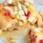 Indulge a little with this Baked Brie with Sweet Hot Pepper Jelly and Pear. Hot and sweet, creamy with a little crunch and a whole lot of deliciousness. Served as an appetizer or dessert, it is sure to be a crowd pleaser.