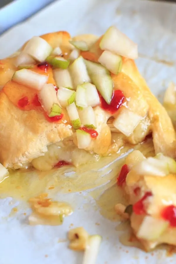 Indulge a little with this Baked Brie with Sweet Hot Pepper Jelly and Pear. Hot and sweet, creamy with a little crunch and a whole lot of deliciousness. Served as an appetizer or dessert, it is sure to be a crowd pleaser.