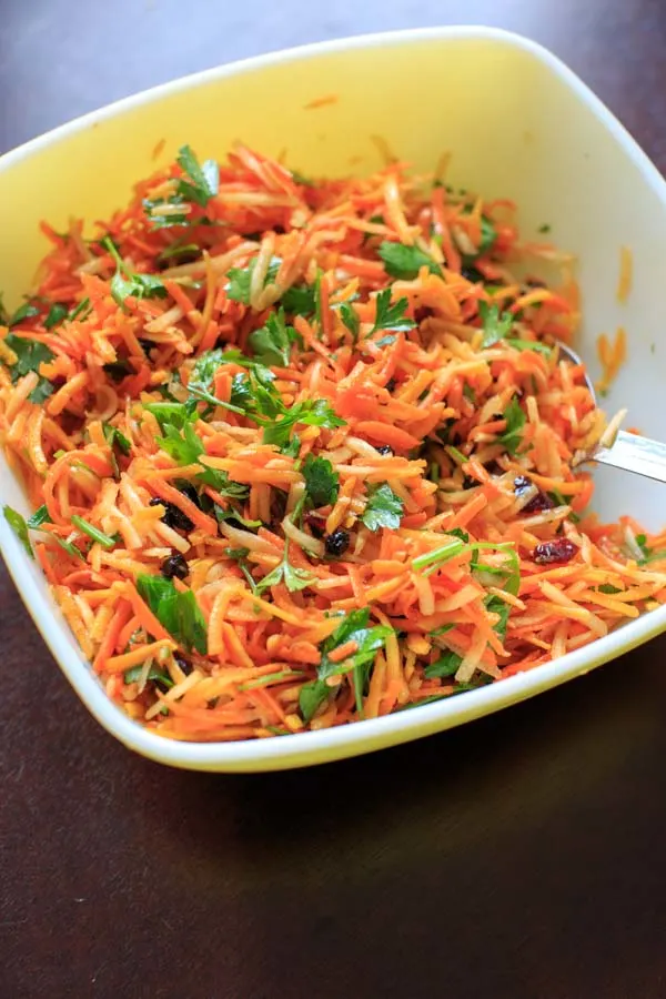 Multicolored Shredded Carrot Salad with dried cranberries, dried blueberries and parsley. A beautiful and healthy side dish that is vegan and gluten free.