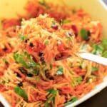 Multicolored Shredded Carrot Salad with dried cranberries, dried blueberries and parsley. A beautiful and healthy side dish that is vegan and gluten free.