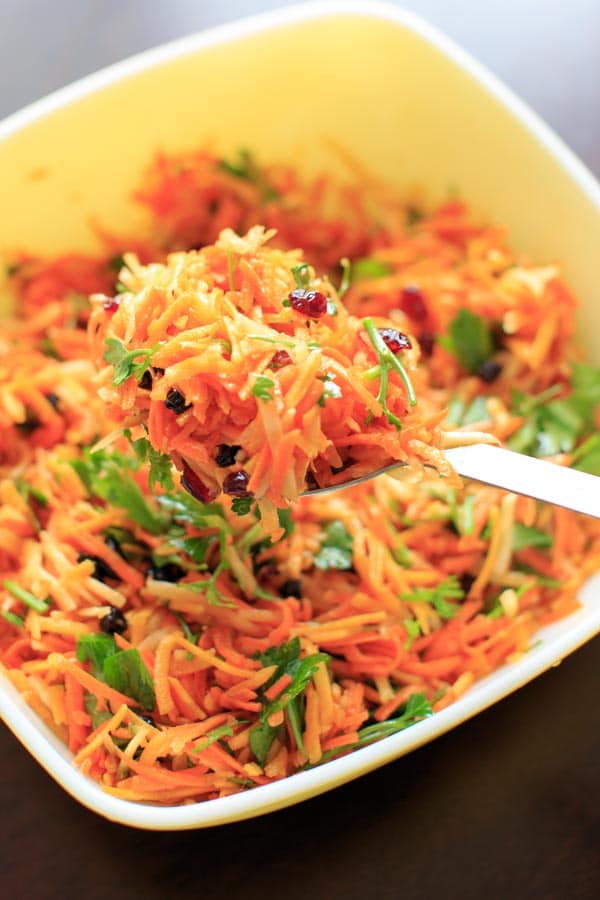 Multicolored Shredded Carrot Salad with dried cranberries, dried blueberries and parsley. A beautiful and healthy side dish that is vegan and gluten free.