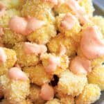 Skinny Bang Bang Cauliflower - a lightened up version of bang bang sauce, paired with oven baked cauliflower florets. Spicy, delicious, and healthy!