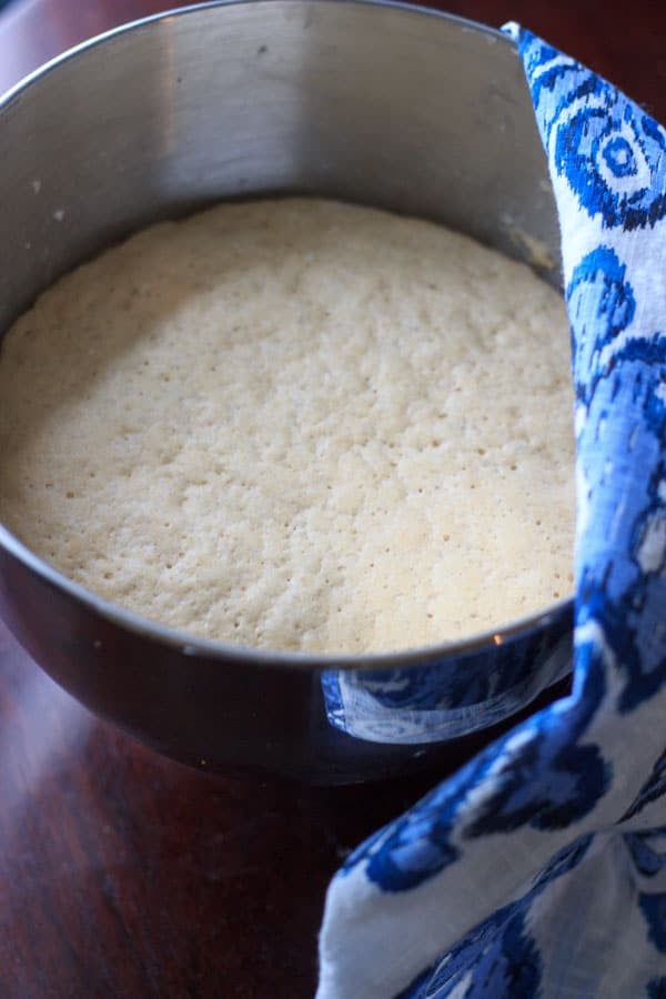 vegan pizza dough rising in mixing bowl