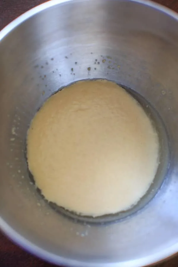 proofing the yeast for easy homemade pizza dough in mixing bowl