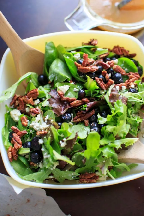 Prepping Italian blue salad in a big salad bowl