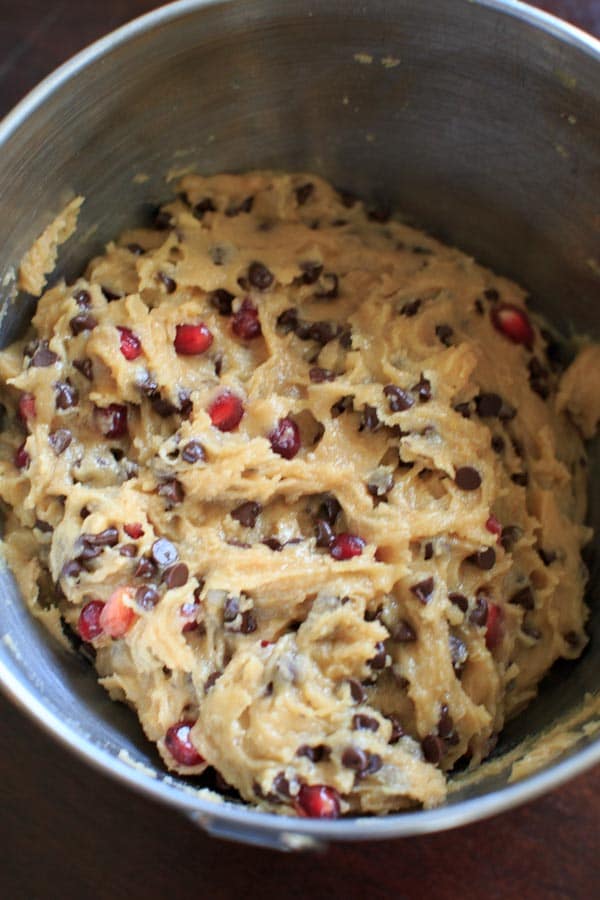 Chocolate Chip Cookie dough with Pomegranate Seeds in mixing bowl