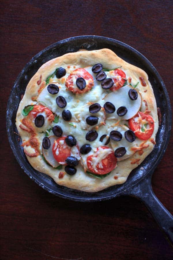 Homemade Pizza with Truffle Oil, Pear, Black Olives. A sweet and salty combo to give pizza night a unique and delicious spin.