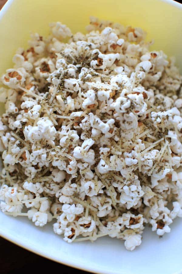 Pizza popcorn is a perfect snack for movie night that's still pretty healthy and full of flavor with dried herbs and parmesan cheese.