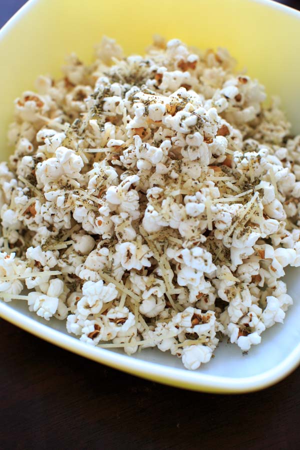 Pizza popcorn is a perfect snack for movie night that's still pretty healthy and full of flavor with dried herbs and parmesan cheese.